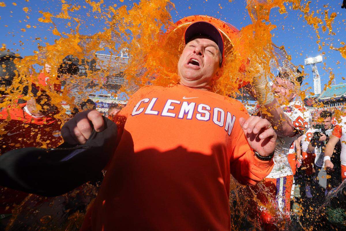 Clemson head coach Dabo Swinney is doused after his team’s Gator Bowl win against Kentucky at EverBank Stadium in Jacksonville, Florida.
