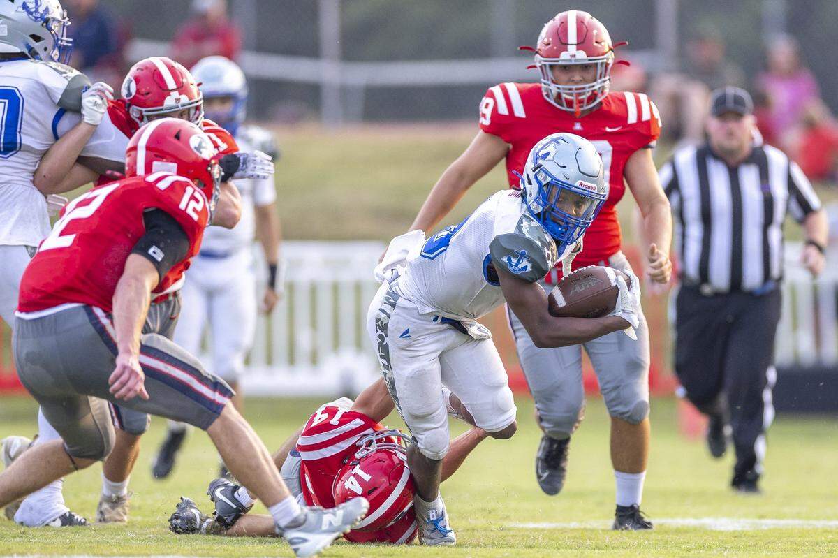 Danville's Trinden Sellers (9) runs the ball as Anderson County's Clay Smith (14) tries to bring him down during a game in Lawrenceburg, Ky., on Friday, Sept. 5, 2025.