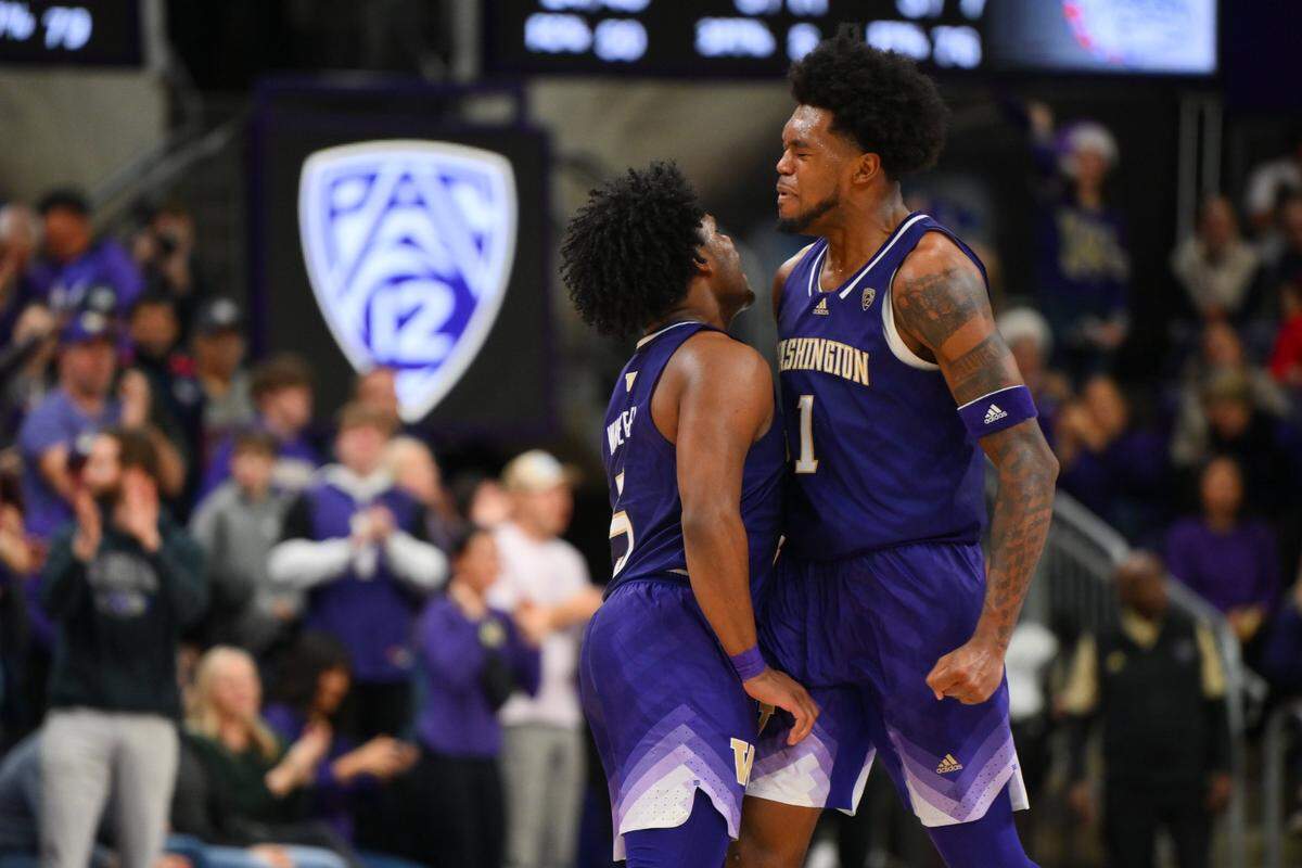 Washington’s Sahvir Wheeler, left, and Keion Brooks Jr., both former Kentucky Wildcats, celebrate after a basket against Gonzaga during the second half in Seattle on Saturday night.