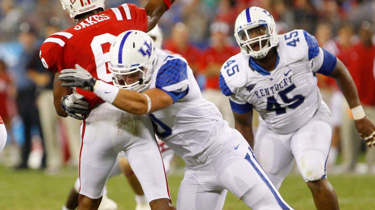 Western Kentucky quarterback Kawaun Jakes (6) got hit by Kentucky linebacker Tyler Brause (10) during the Wildcats' 14-3 victory over the Hilltoppers last season in Nashville. Jakes threw four interceptions in the game.
