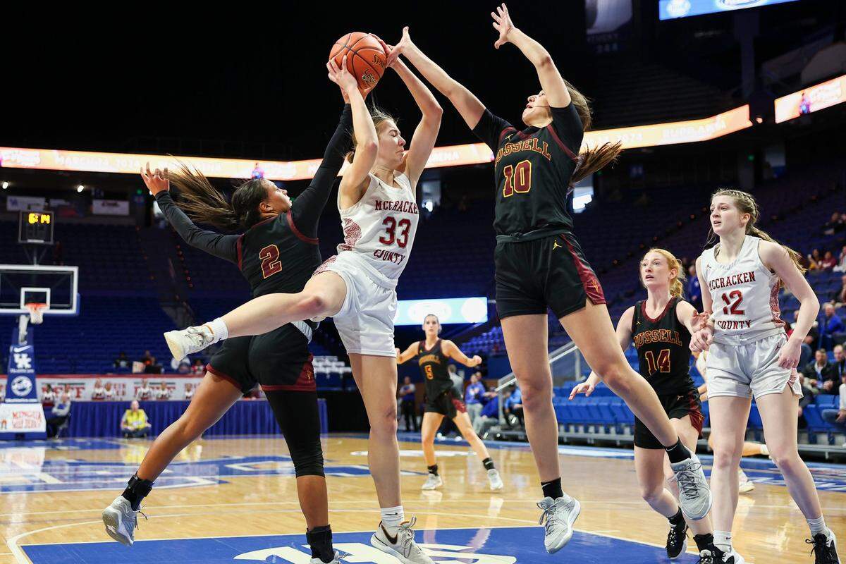 Mikee Buchanan (33) secures a rebound against Russell’s Kennedy Darnell (10). Buchanan finished with eight points and six boards.