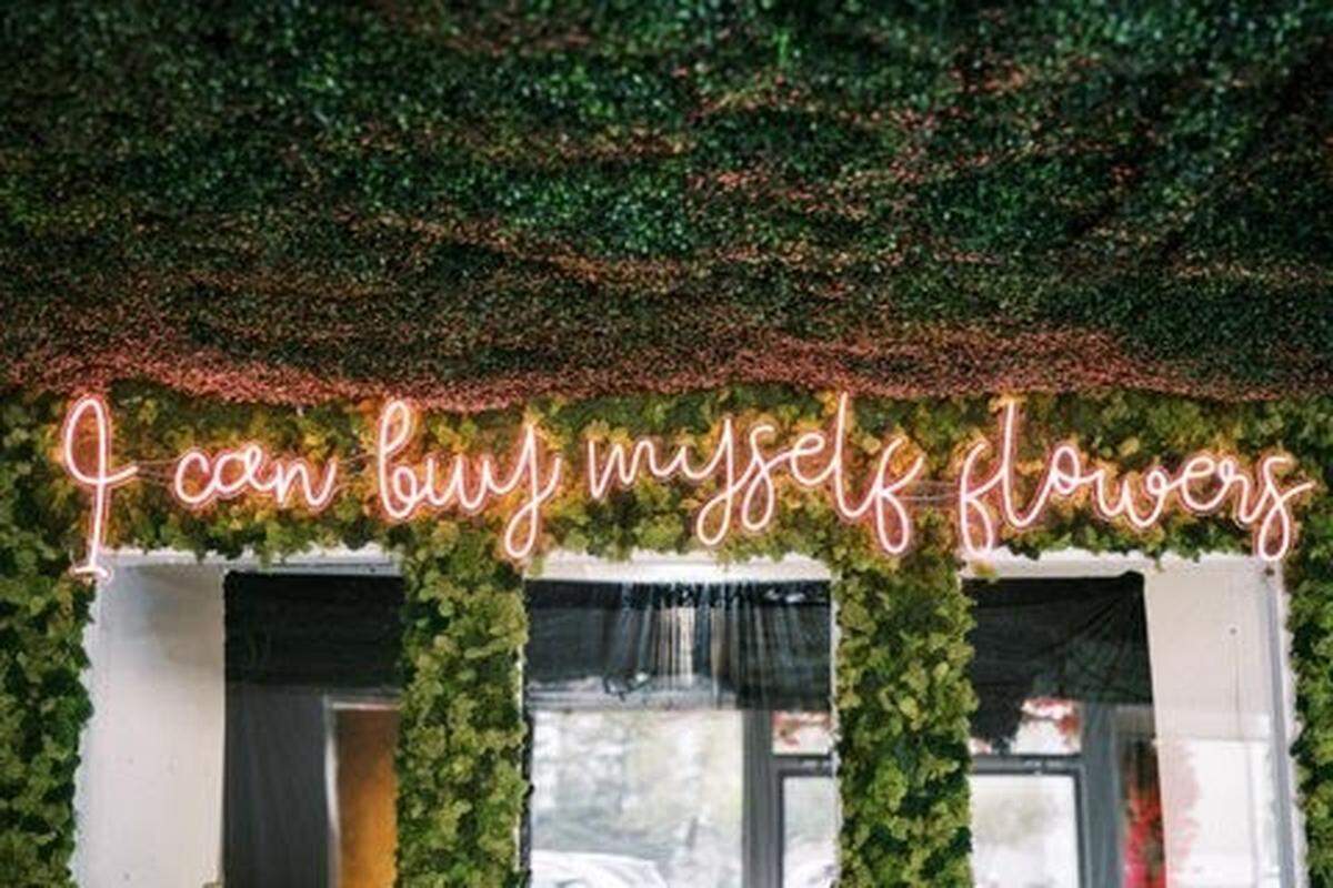 A sign at Poppy’s Flower Bar, a new flower shop and cocktail bar on Old Mt. Tabor Rd., has a sign that says, “I can buy myself flowers”.