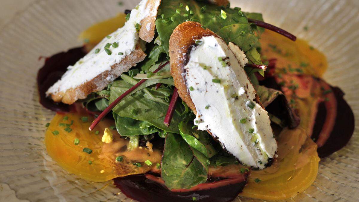 This salad has arugula, roasted beets and goat cheese.