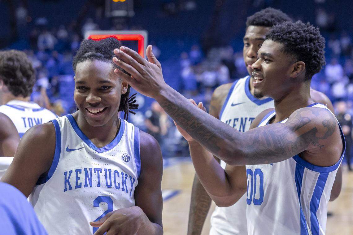 Kentucky guard Otega Oweh (00) jokes with guard Jasper Johnson (2) following Tuesday’s game against Nicholls at Rupp Arena.
