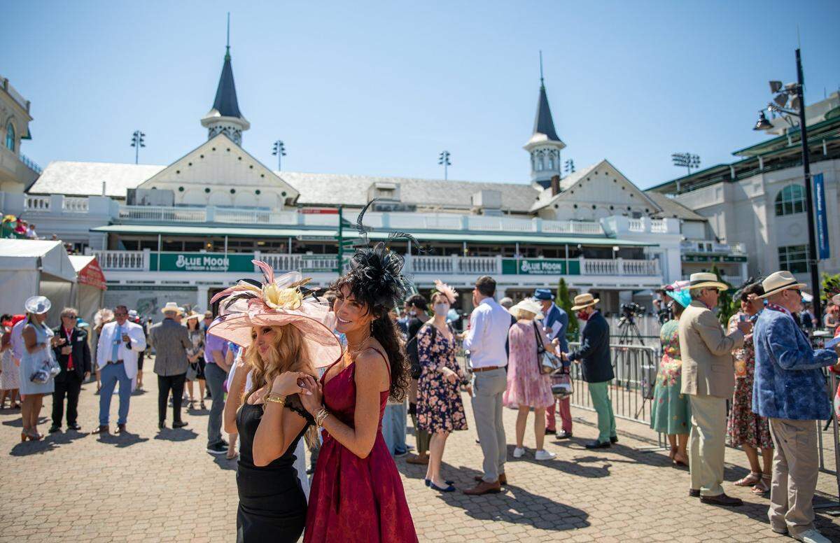 Spectators take photos in front of the Twin Spires at Churchill Downs in Louisville, Ky., as races begin at the 147th Kentucky Derby on Saturday, May 1, 2021.