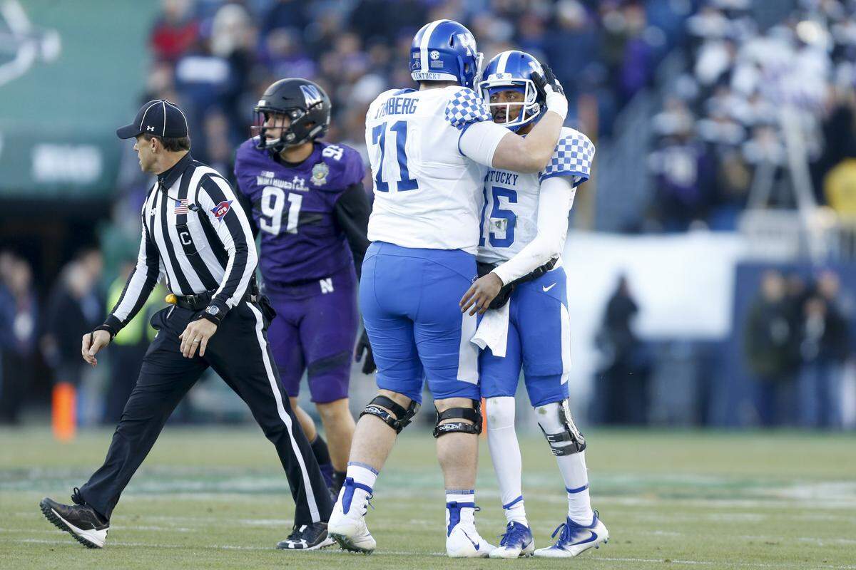Kentucky Wildcats guard Logan Stenberg (71) congratulated quarterback Stephen Johnson after a pass during the first half of UK’s 24-23 loss to Northwestern in last season’s Music City Bowl..