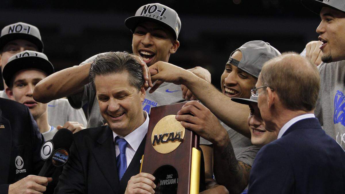 Kentucky Coach John Calipari held the trophy after the Cats defeated Kansas in the 2012 NCAA championship game.