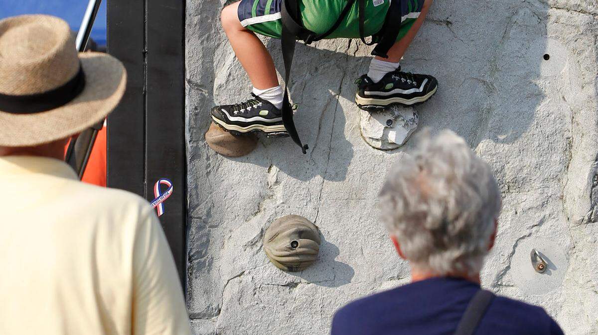 Under the watchful eyes of his grandparents Gerald and Marie Wedding of Owensboro, Cooper Wedding, 6, climbed the rock wall. It was one of several child-friendly attractions.