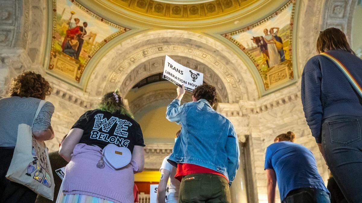 Christian Brawner, of Louisville, holds a “Trans Liberation Now” sign during the Fairness Rally at the Kentucky state Capitol in Frankfort, Ky., on Wednesday, Feb. 15, 2023.