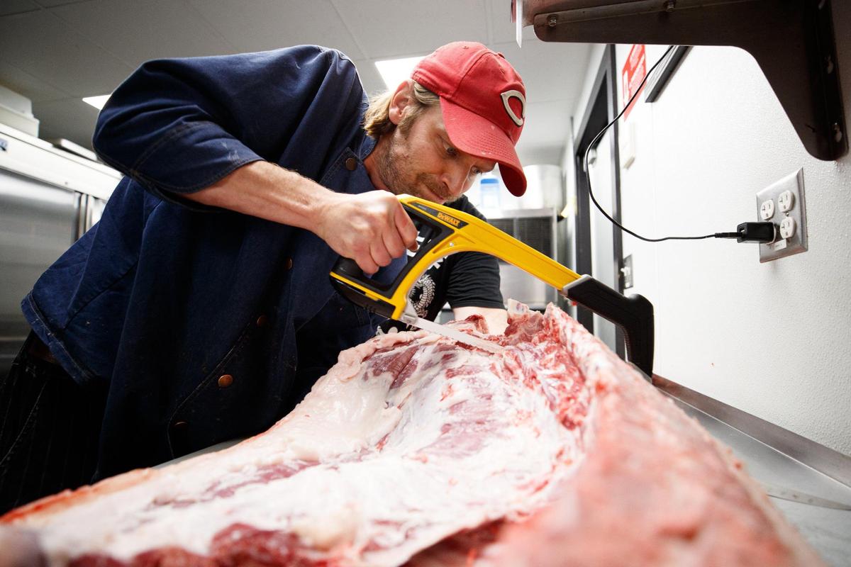 Salt & Vinegar chef and owner Greg Spaulding breaks down a delivery of a whole pig on June 23, 2022, at Ethereal Brewing Public House in Lexington, Kentucky. He will butcher the whole hog for pork chops, pancetta, bacon, using the shoulders and hams to make bratwurst, the head to make terrines and “great stock from the bones.”