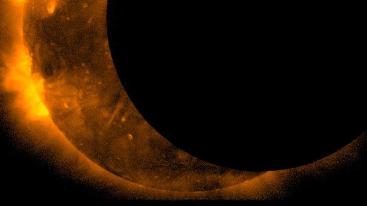 The joint JAXA/NASA Hinode mission captured these images of an annular eclipse of the Sun on May 20, 2012.  During an annular eclipse the moon does not block the entirety of the sun, but leaves a bright ring of light visible at the edges. For the May eclipse, the moon was at the furthest distance from Earth that it ever achieves – meaning that it blocked the smallest possible portion of the sun, and leaves the largest possible bright ring around the outside.  Scientists often use an eclipse to help calibrate the instruments on the telescope by focusing in on the edge of the moon as it crosses the sun and measuring how sharp it appears in the images. Photo shared via Wikimedia Commons. 