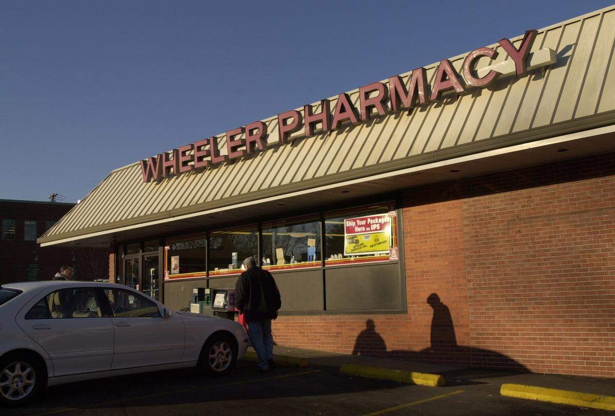 Customers enter Wheeler’s Pharmacy as it opens at 9 a.m., where a regular crowd enjoys breakfast together in Lexington, Ky., on 1/4/02.