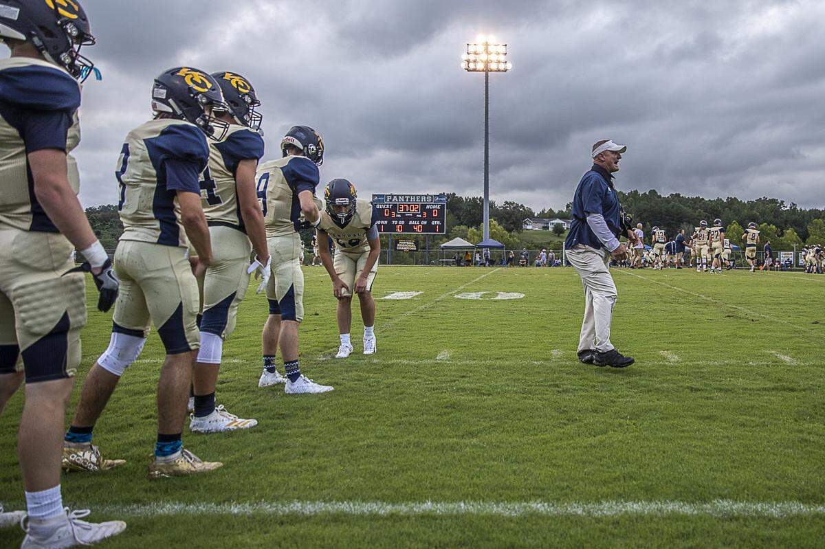 Knox Central assistant coach Chaz Martin leads the Panthers in warmups before their game against Ashland Blazer.