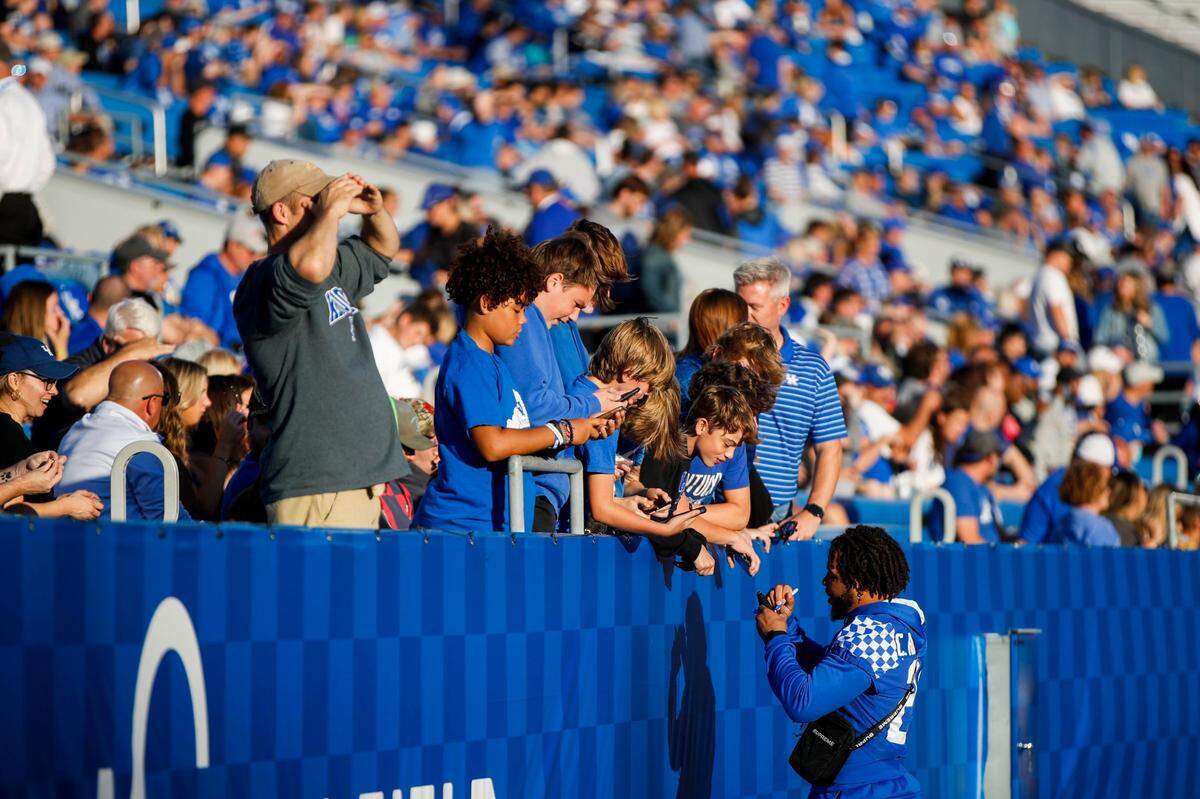 Kentucky running back Christopher Rodriguez signs autographs for fans before UK’s 31-23 win over Northern Illinois.