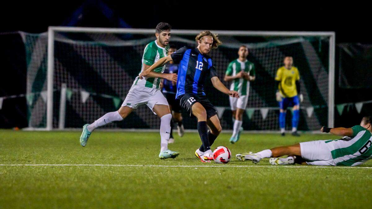 Kentucky’s Clay Holstad dribbled the ball past a Marshall player during the team’s match Saturday night at Hoops Family Field in Huntington, W.Va. The teams played to a 0-0 draw in the second C-USA match of the season for each.