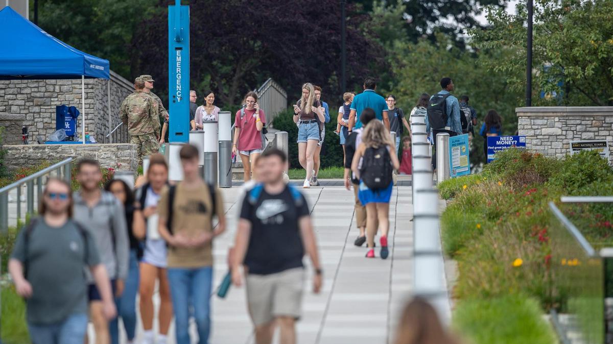 People walk along the University of Kentucky campus in Lexington, Ky., on Monday, Aug. 22, 2022.