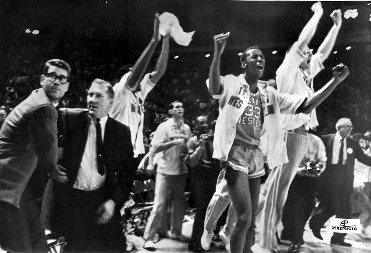Texas Western basketball coach Don Haskins, second from left, and players celebrated after beating Kentucky to win the 1966 NCAA basketball championship in College Park, Md.
