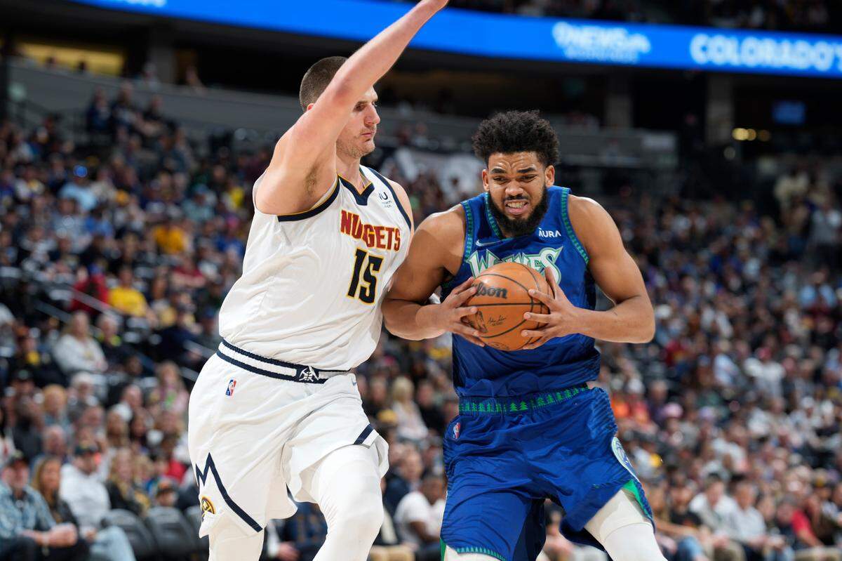 Minnesota Timberwolves center Karl-Anthony Towns, right, drives the lane as Denver Nuggets center Nikola Jokic defends on April 1. Towns shot 41.0% from long range during the regular season and won the three-point contest at the 2022 NBA All-Star Game.