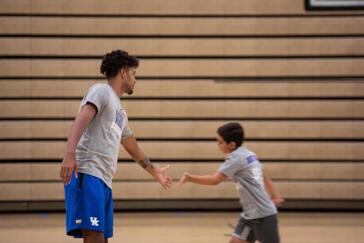 Dontaie Allen encourages a camper during Wednesday’s UK team appearance at Ryle High School.