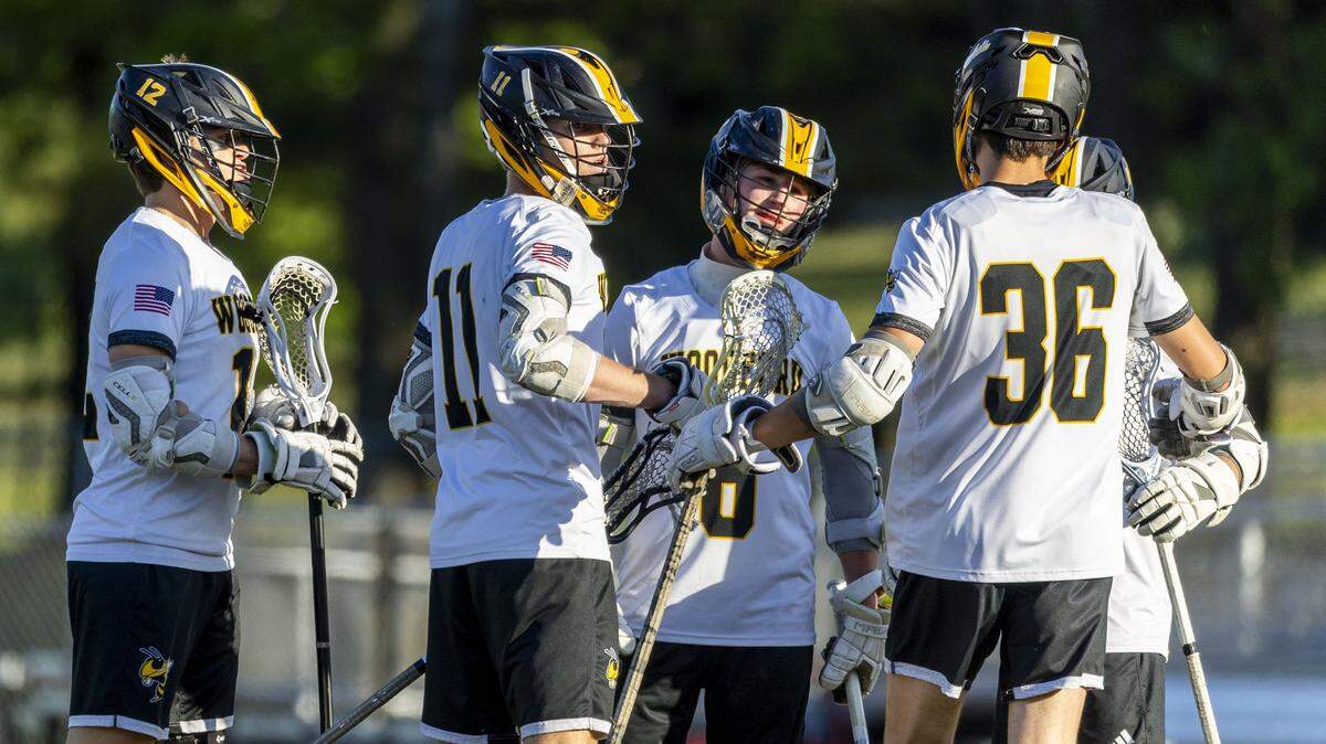 From left, Woodford County's Cole Humston (12), Woodford County's Brayden Humston (11), Woodford County's Greyson Hodge (6) and Woodford County's Drew Sumner (36) celebrate a goal during the Yellow Jacket's 19-4 win over Lafayette in the boys' high school lacrosse 8th District championship game, Monday, May 11, 2026 at Paul Laurence Dunbar High School in Lexington, Ky.