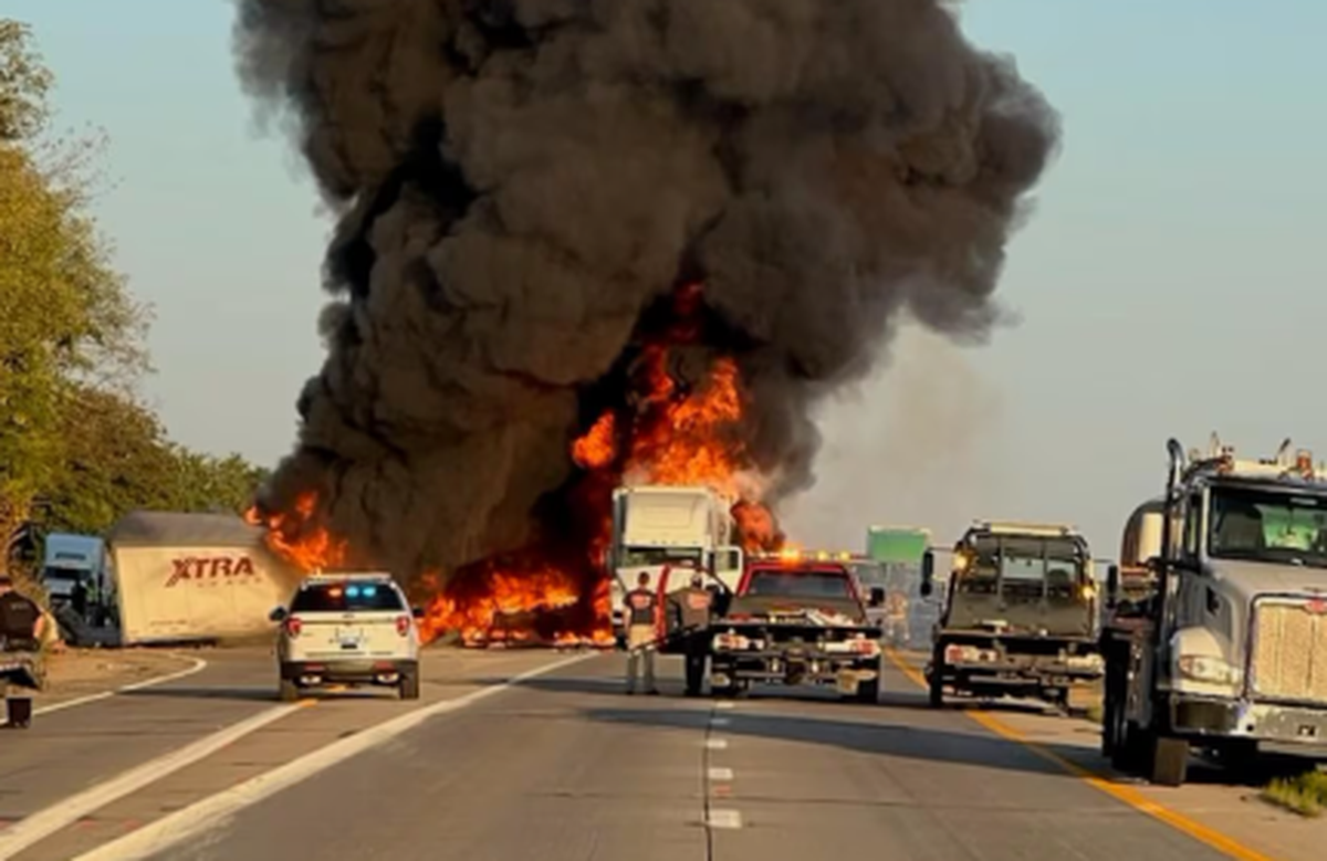 Smoke billowed high above a fire that broke out as a result of a crash Friday night on Interstate 64 in Woodford County, Kentucky.