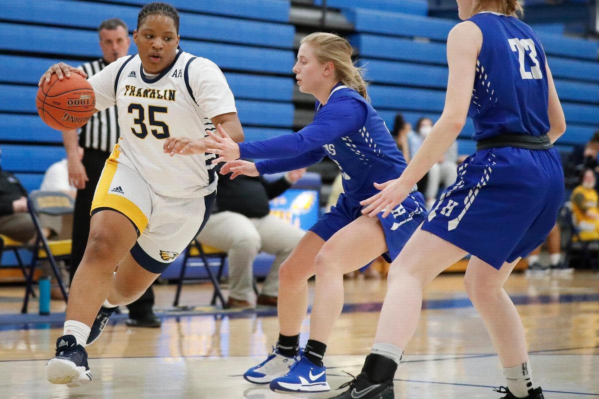 Franklin County’s Patience Laster (35) dribbles around Highlands’ Kelsey Listerman (20) and Emma Mallery (23) during a game in Frankfort last month. Franklin County won the 11th Region.