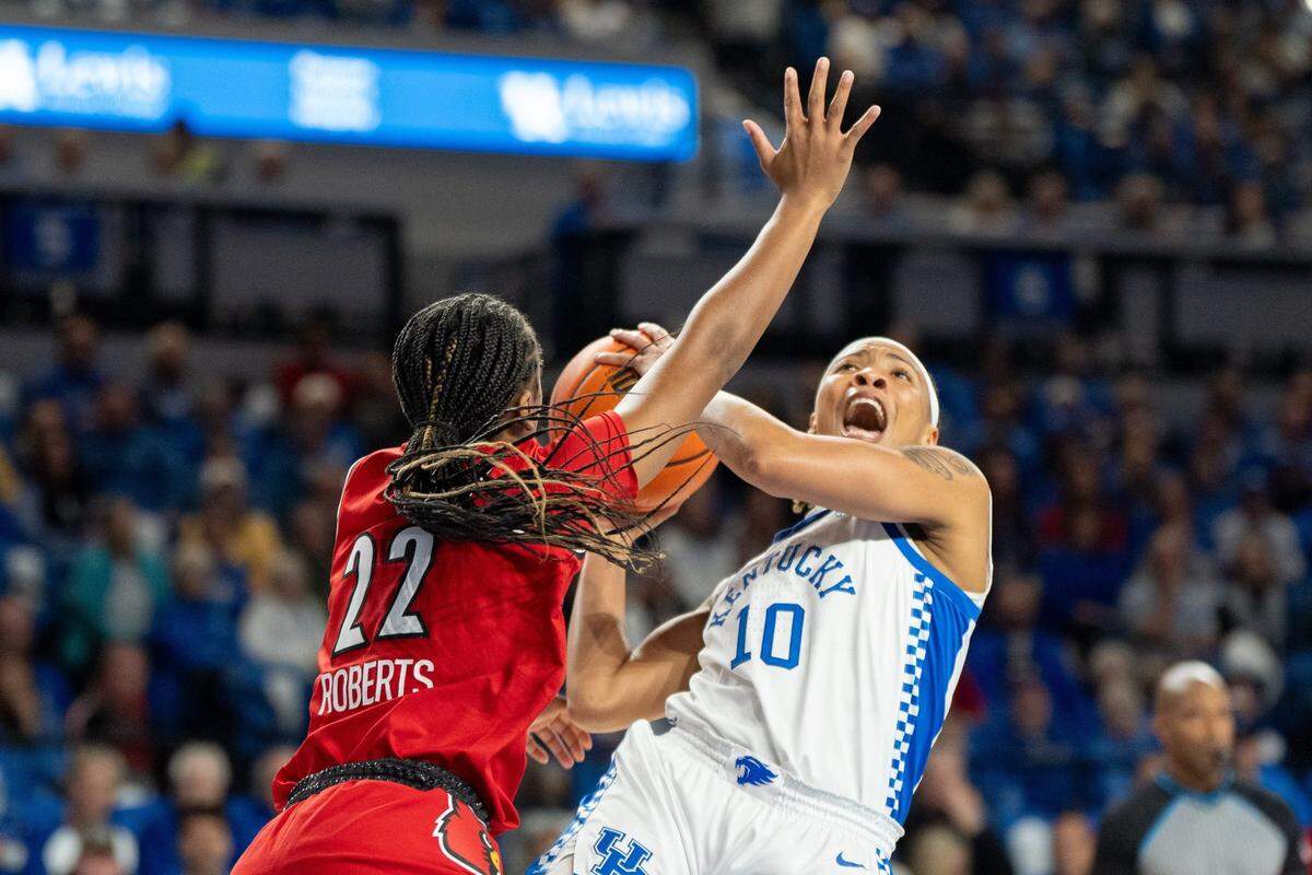 Kentucky Wildcats guard Dazia Lawrence (10) goes for a layup against Louisville Cardinals guard Tajianna Roberts (22) during their game on Saturday, Nov. 16, 2024 at Memorial Coliseum in Lexington, Ky.