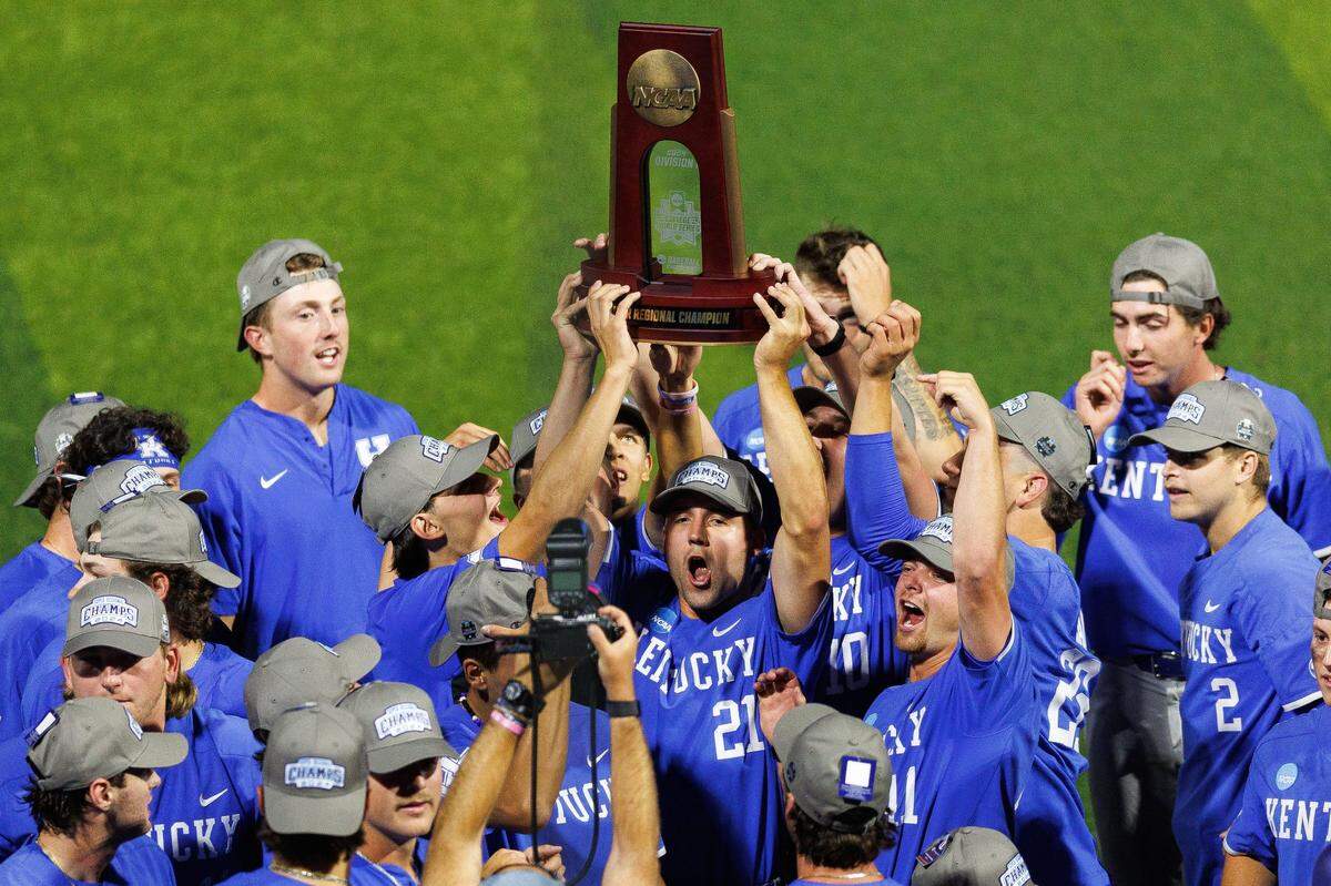 Jun 9, 2024; Lexington, KY, USA; Kentucky Wildcats outfielder Ryan Waldschmidt (21) holds up the NCAA Super Regional Championship trophy after winning against the Oregon State Beavers at Kentucky Proud Park. Mandatory Credit: Jordan Prather-USA TODAY Sports