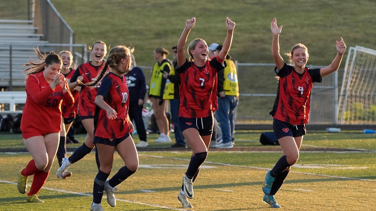 Sacred Heart players, including Nora Dimmitt (10), Lilly Lund (7) and Caitlin Chase (9), celebrate the Valkyries’ 3-1 win over Lexington Catholic in the girls state tournament championship game at Paul Laurence Dunbar High School.