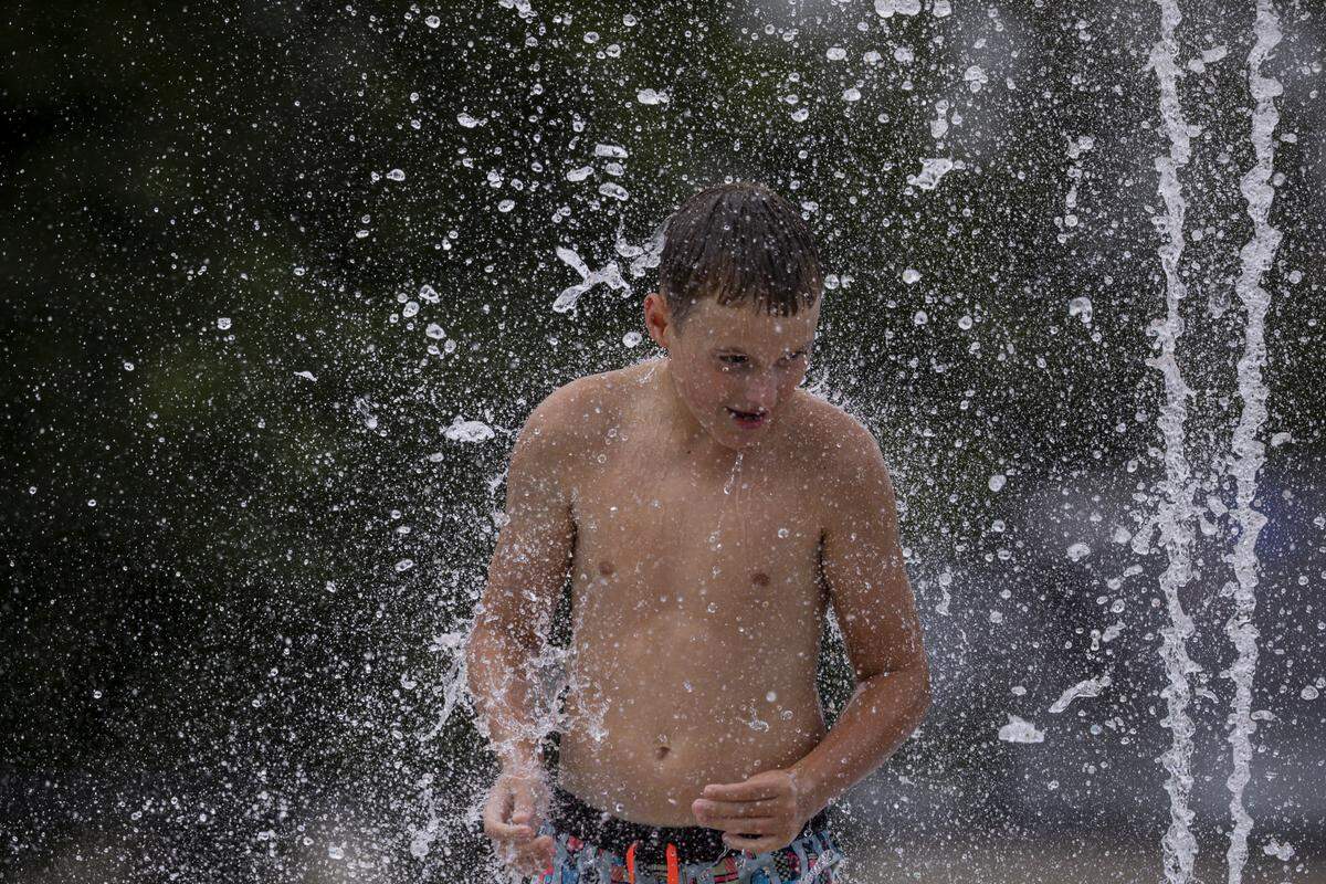 A child plays in the water during the Douglass Aquatic Center opening on Thursday, Aug. 21, 2025, at Douglass Park in Lexington, Ky. 
