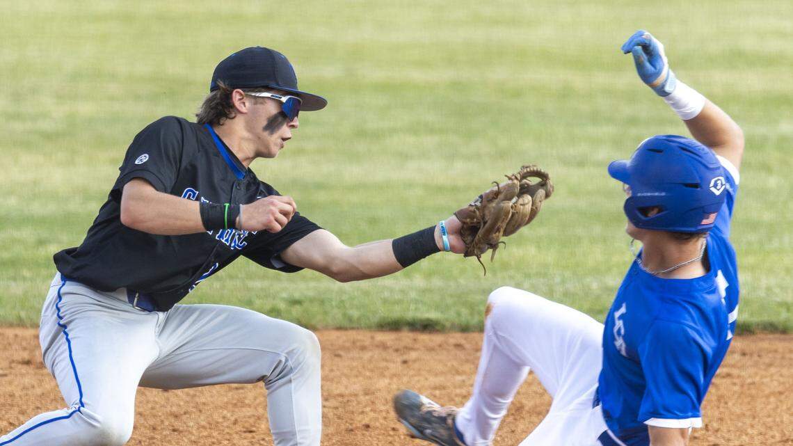 Lexington Catholic's Baird Woodall (28) tags out Lexington Christian's Sam Pearson (3) at second base during a 43rd district high school baseball game, Tuesday, April 28, 2026 at Lexington Christian High School in Lexington, Ky.