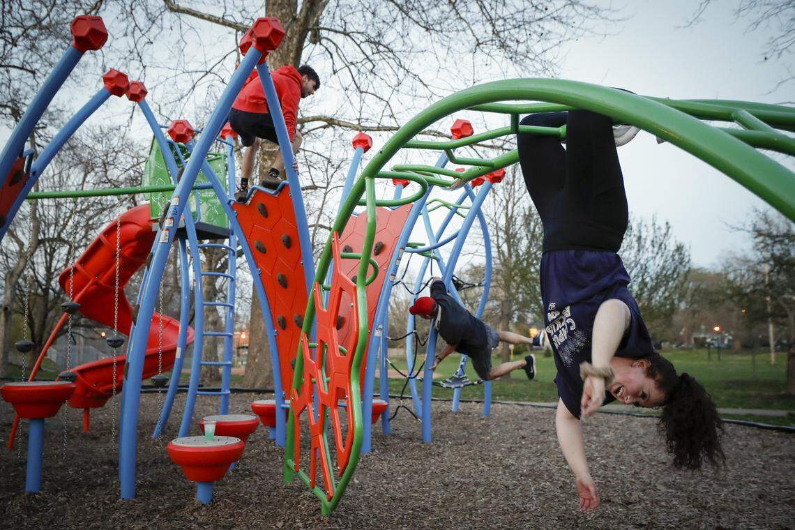 Riley Culbertson, from left, Tracy Culbertson and Maggie Ellis., all of Lexington, Ky., climb one the playground at Woodland Park in Lexington, Thursday, March 26, 2020.
