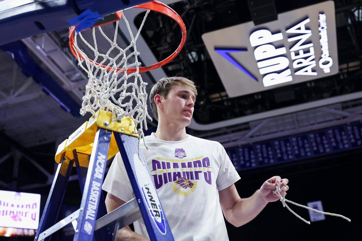 Lyon County’s Travis Perry (11) cuts a part of the net after defeating Harlan County 67-58 during the KHSAA boys’ Sweet 16 championship game at Rupp Arena in Lexington, Ky, Saturday, March 23, 2024.
