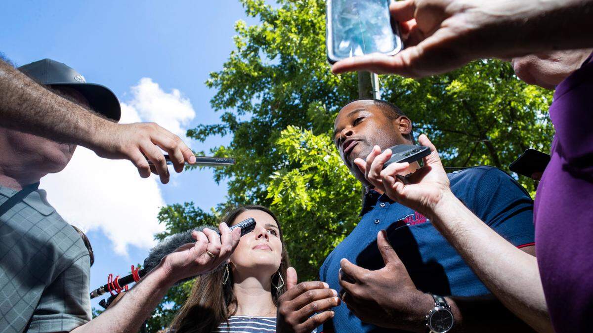 Kentucky Attorney General Daniel Cameron talks with reporters before politicians give speeches during the 142nd annual St. Jerome’s Fancy Farm Picnic in Fancy Farm, Ky., Saturday, August 6, 2022.