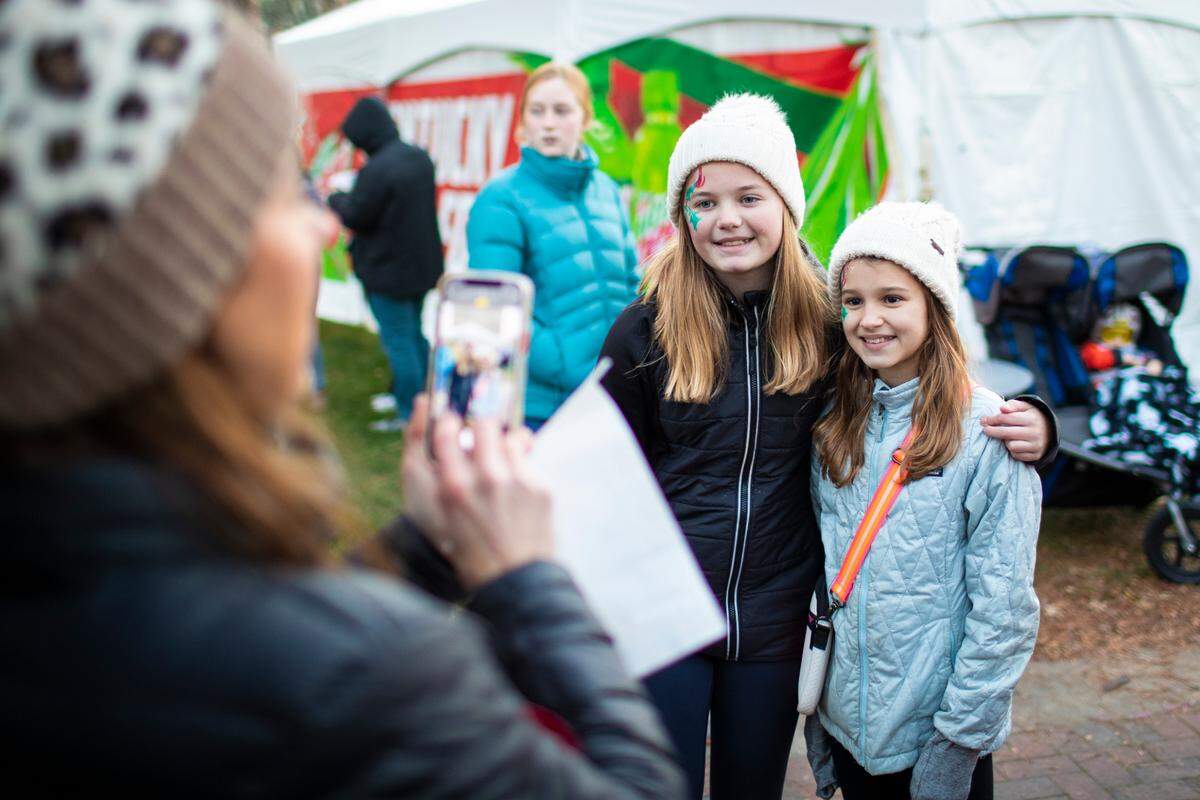 Taryn Meek, 11, took a photo with her friend Maggie Hill, 12, after having their faces painted.