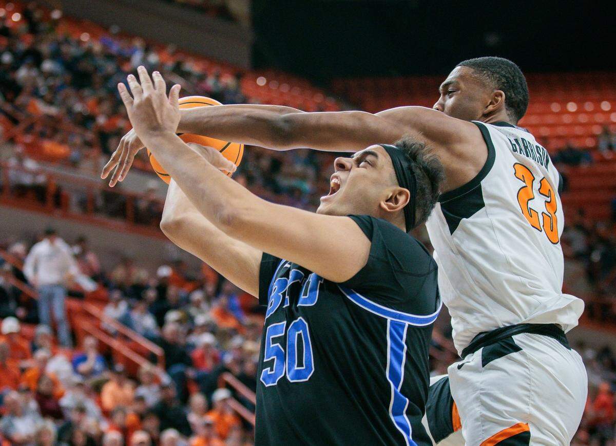 Oklahoma State center Brandon Garrison knocks a ball away from BYU’s Aly Khalifa during a 93-83 win over the Cougars last season. Garrison had a career-high 21 points in that game against coach Mark Pope’s former team.