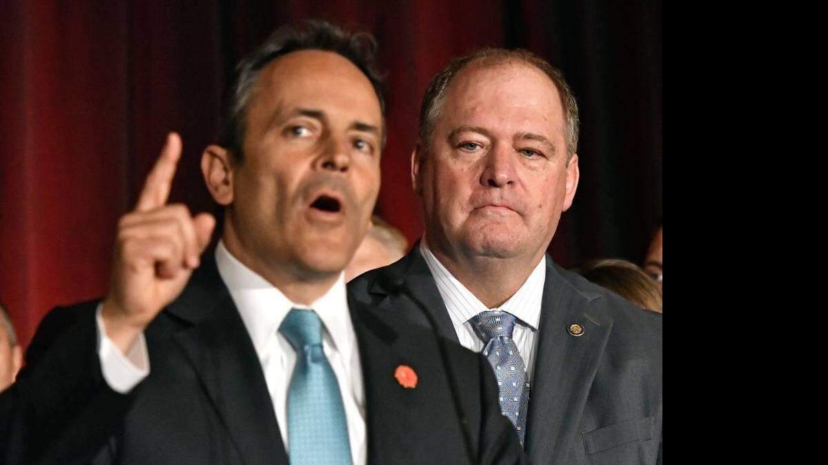 Kentucky Governor Matt Bevin, left, addresses the crowd gathered to celebrate the Kentucky House of Representatives obtaining a republican majority, Tuesday, Nov. 8, 2016 in Louisville, Ky. At right is Kentucky House Majority Leader Jeff Hoover, R- Jamestown. 