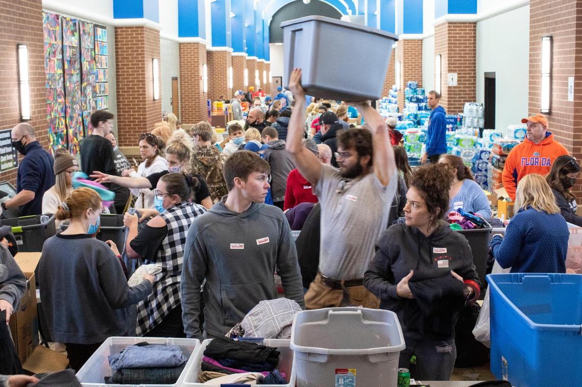 Red Cross volunteers work to drop off, sort and gather essential supplies from donations for people whose homes were destroyed or damaged by tornados at South Warren High School in Bowling Green, Ky., Sunday, December 12, 2021.