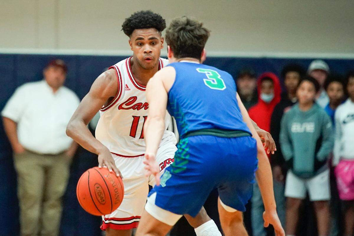 Clark County’s Jerone Morton (11) drives against North Laurel’s Reed Sheppard (3) in the Cardinals’ 77-64 win over the Jaguars in Lexington in December. Clark County is 26-1.