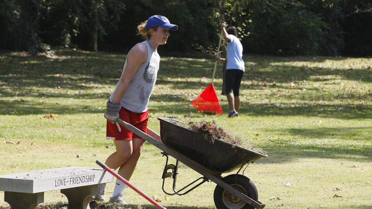 First-year medical student Lindsay Williams moved a wheelbarrow of sod in Section 36 at Lexington Cemetery, which is used to bury the cremated remains of those who have donated their bodies to the University of Kentucky College of Medicine to further medical training and research.