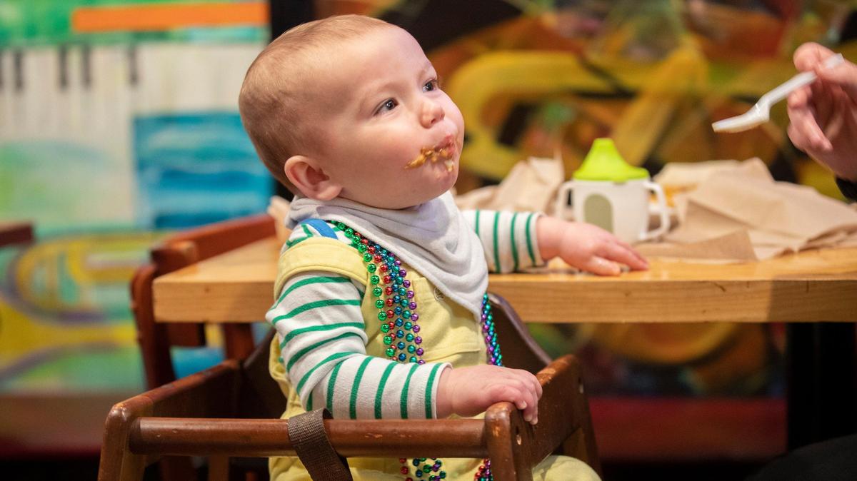 Wyler Johnson, 1, wore Mardi Gras beads in honor of Fat Tuesday and tried out the Southwest etouffee with Crawfish, with a little help from his mother, Ashley Johnson, of Georgetown, at Bourbon n’ Toulouse in Lexington Tuesday.