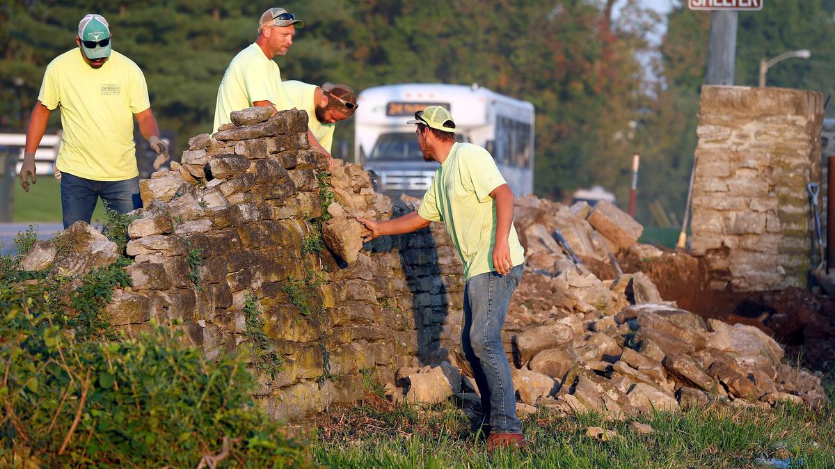 James Miles Construction and Stone Work employees left to right: Mario Centeno, Doug Isaac, Jeffery Stewart, Brandon Isaac, worked Monday morning on rebuilding about 800-linear feet of the stone fence along Old Frankfort Pike near the old landfill pad.