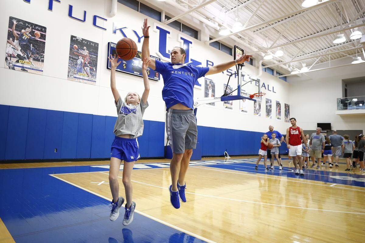 Sophie Hollenkamp, 11, of Crescent Springs, Ky., shoots a basket past her father Drew Hollenkamp, also of Crescent Springs, during The inaugural John Calipari Father/Daughter Camp at the Joe Craft Center in Lexington, Ky., Saturday, June 22, 2019.