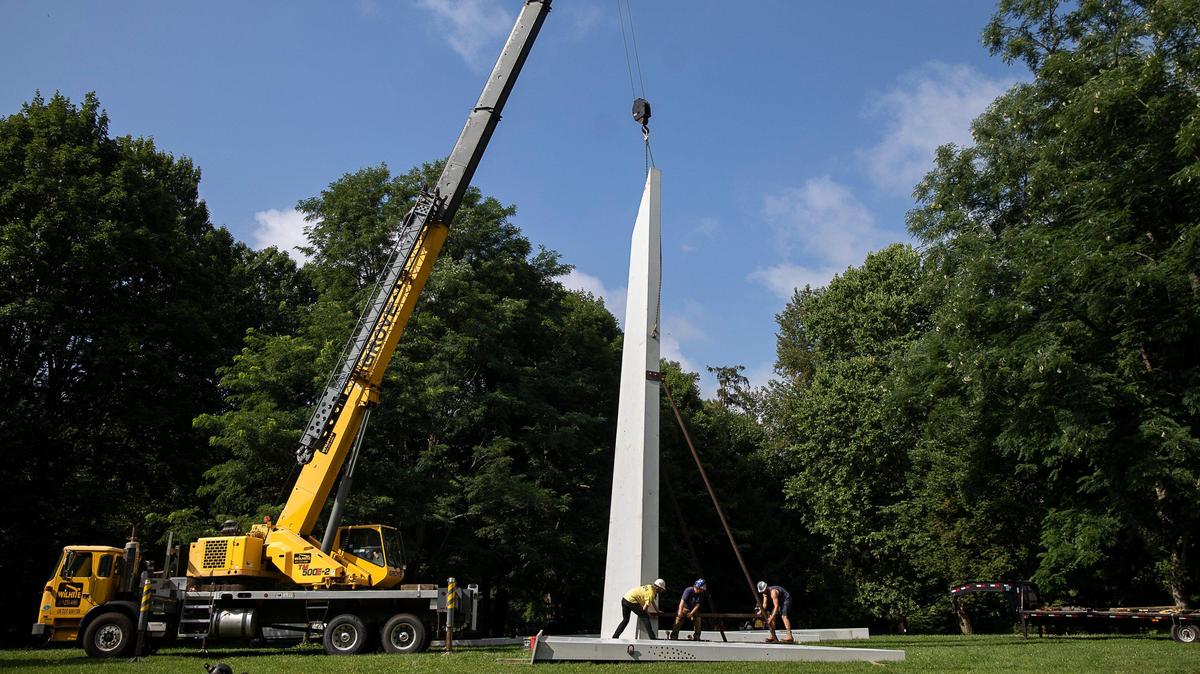 Workers install “Publisher,” a sculpture by John Henry Sculpture, at Ashland, the Henry Clay Estate in Lexington, Ky., Monday, July 8, 2019.