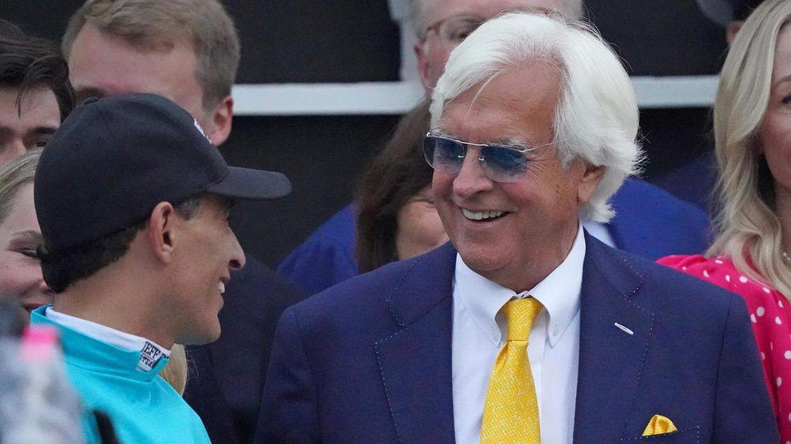 Trainer Bob Baffert, right, and jockey John Velazquez meet in the winner’s circle after their victory with National Treasure in the Preakness Stakes on Saturday. Baffert set a record with his eighth Preakness win.