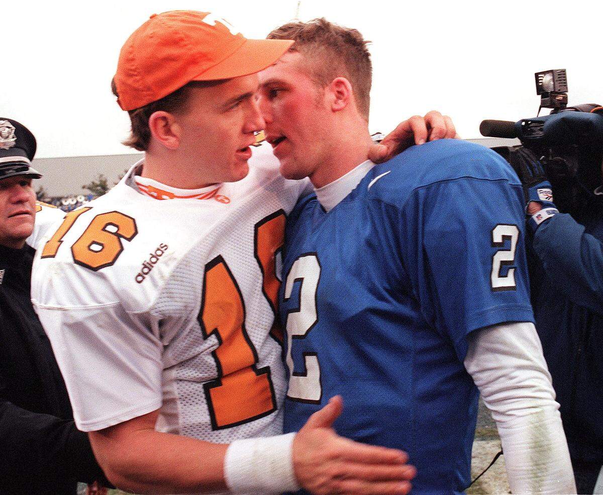 Tennessee's Peyton Manning, left,  and Kentucky's Tim Couch, right, after the Volunteers’ 59-31 win over the Cats on Nov. 22, 1997, at Commonwealth Stadium. Manning would go on to become the No. 1 overall pick in the 1998 NFL draft, while Couch would be chosen No. 1 overall in the 1999 NFL draft.
