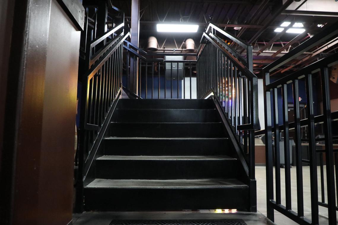 Stairs lead to the rooftop patio bar at 2 Fisted Willie’s on Woodland Avenue.
