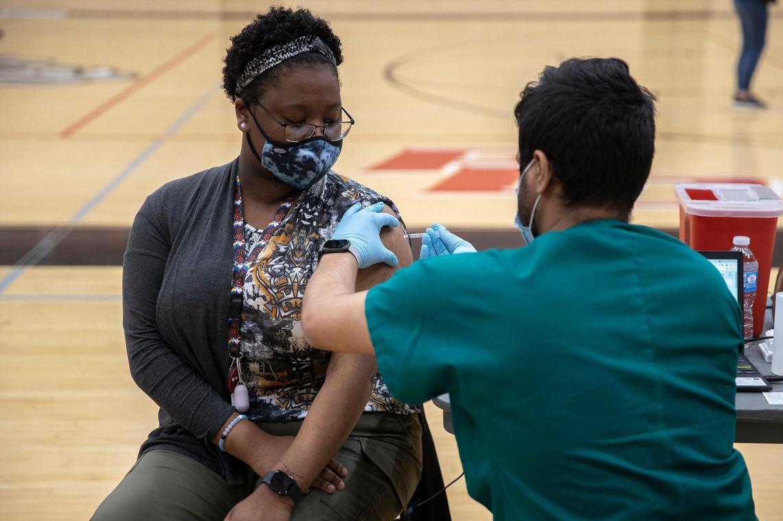 Teqeila Plunkett, a senior at Paul Laurence Dunbar, receives the COVID-19 vaccination at the high school in Lexington, Ky., on Tuesday, April 27, 2021. The vaccines were administered at six Lexington high schools Tuesday and were available for students age 16 and older, their families and school staff.