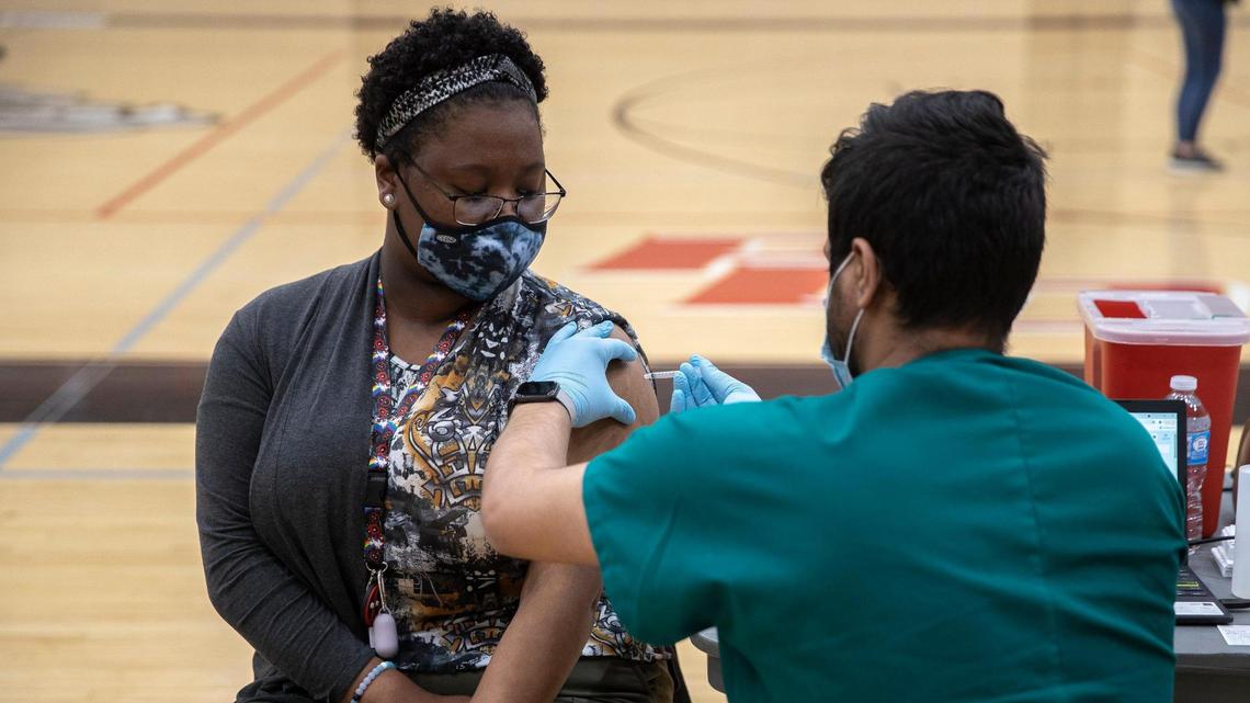 Teqeila Plunkett, a senior at Paul Laurence Dunbar, receives the COVID-19 vaccination at the high school in Lexington, Ky., on Tuesday, April 27, 2021. The vaccines were administered at six Lexington high schools Tuesday and were available for students age 16 and older, their families and school staff.