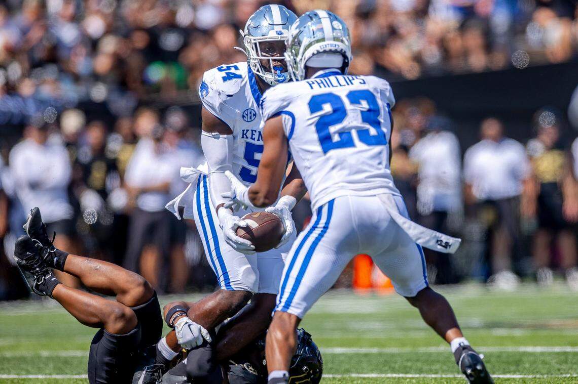 After intercepting the ball, Kentucky linebacker D’Eryk Jackson (54) pitched it to defensive back Andru Phillips (23) who ran it back for a large gain during UK’s win at Vanderbilt last season.